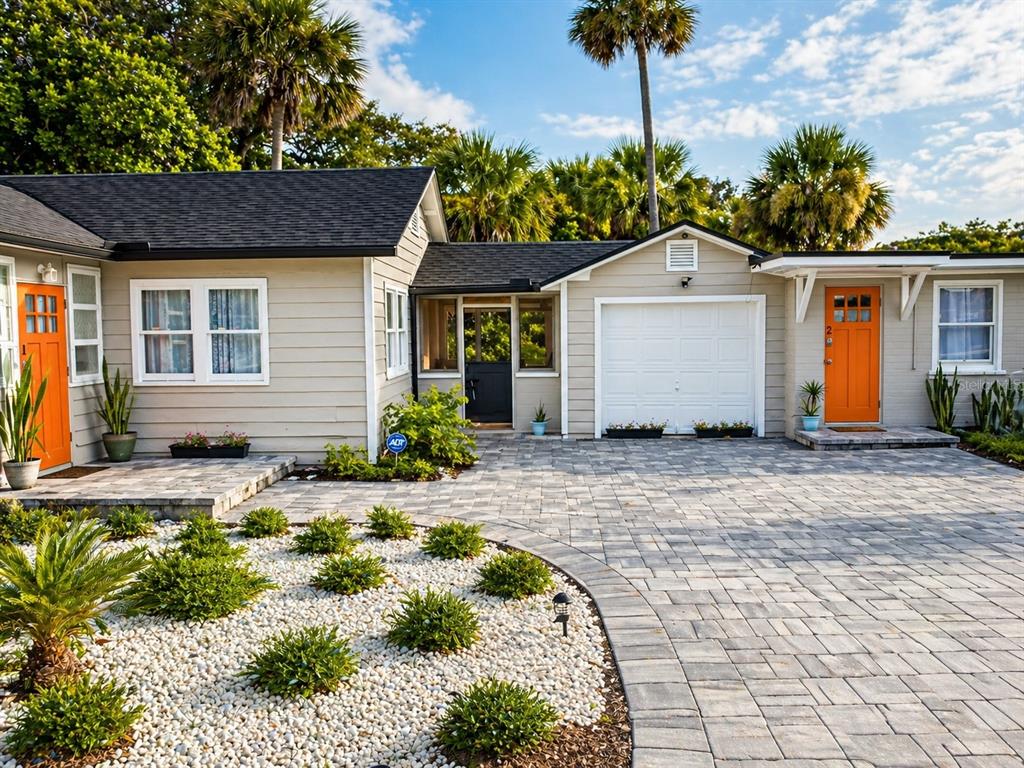 An aerial view shows a building with shuffleboard courts, a parking lot, and surrounding trees — 200 S PINE STREET, NEW SMYRNA BEACH, FL