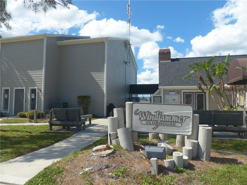 A kitchen island with granite countertops overlooks a living area with sliding glass doors — 1400 GANDY BOULEVARD N UNIT 1010, ST PETERSBURG, FL