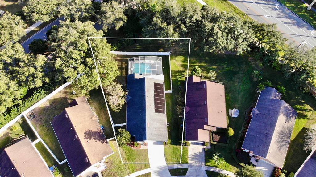 An aerial view shows a single-family home with a screened-in pool and solar panels — 457 MICKLETON LOOP, OCOEE, FL