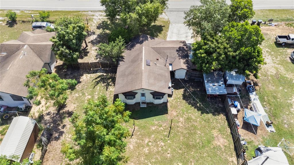 An aerial view shows a single-story house with a brown roof and a large yard — 805 CENTER STREET, DUNDEE, FL