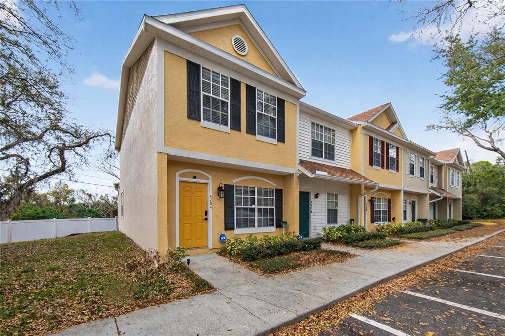 An interior view shows a room with beige tile flooring and a kitchen pass-through window — 4204 PLANTATION COVE DRIVE, ORLANDO, FL