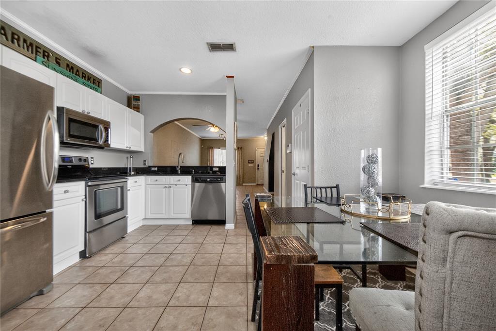 A bathroom features a white vanity with a sink, a toilet, and a bathtub — 4204 PLANTATION COVE DRIVE, ORLANDO, FL