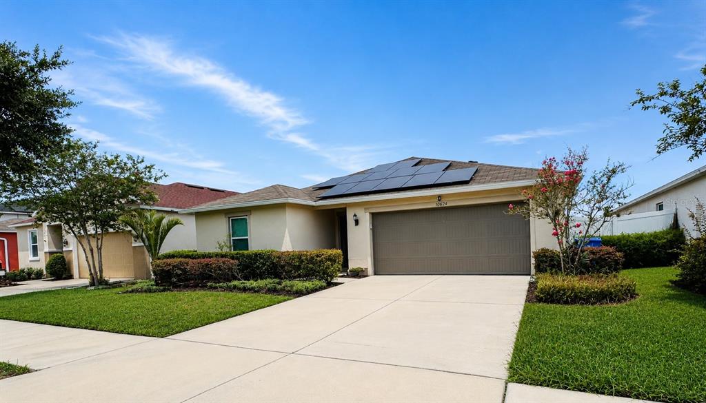 An empty room with light gray walls, tile flooring, and a window with white curtains — 10624 MASSIMO DRIVE, WIMAUMA, FL