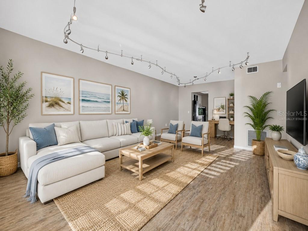 An empty room with light-colored walls, wood-look flooring, and a track lighting system — 6015 19TH STREET N UNIT 215, ST PETERSBURG, FL