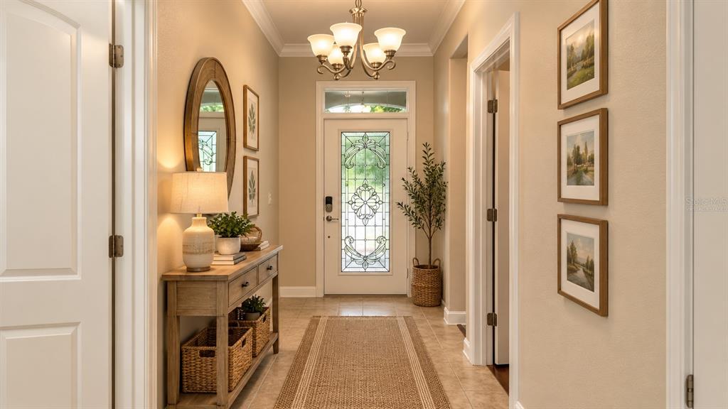 An entryway features a tiled floor, a glass-paneled front door, and a wooden display cabinet — 4056 SERENA LANE, CLERMONT, FL