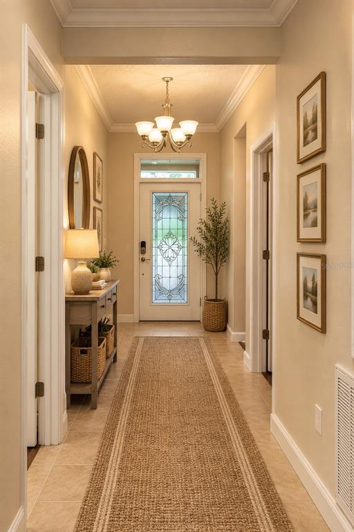 A tiled hallway leads to a living area with sliding glass doors and a chandelier — 4056 SERENA LANE, CLERMONT, FL