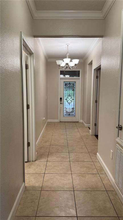 A bedroom features a bed with dark bedding, a dresser with a mirror, and a window — 4056 SERENA LANE, CLERMONT, FL