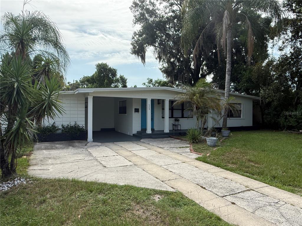 A single-story white house with a carport and a concrete driveway sits on a lawn — 524 N LAKEMONT AVENUE, WINTER PARK, FL