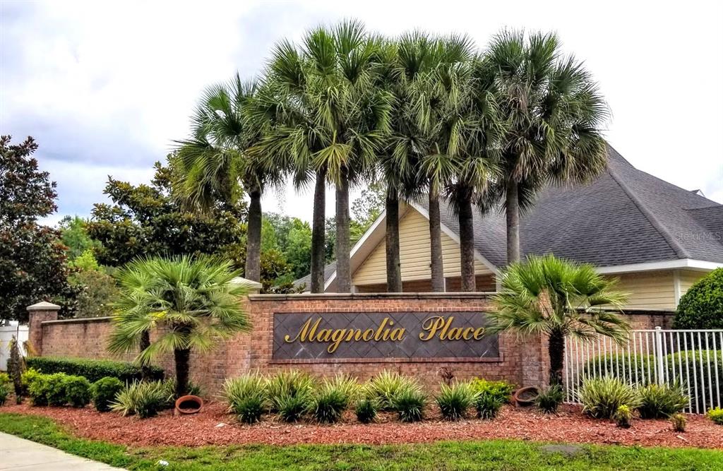 A fitness room features exercise equipment, mirrored walls, and windows with white blinds — 4335 NW 48TH STREET UNIT 105, GAINESVILLE, FL