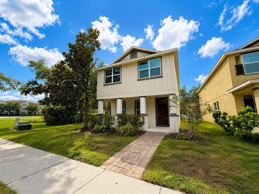 A two-story house with light siding, a covered front porch, and a brick walkway — 11804 SILVERLAKE PARK DRIVE, WINDERMERE, FL