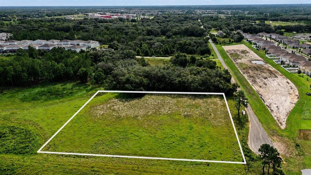 An aerial view shows a rectangular vacant lot outlined in white within a residential neighborhood — BOWEN ROAD, DAVENPORT, FL