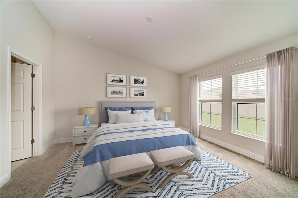 A bedroom features a queen bed, two nightstands with blue lamps, and two upholstered benches — 12361 OAK  HILL WAY, PARRISH, FL