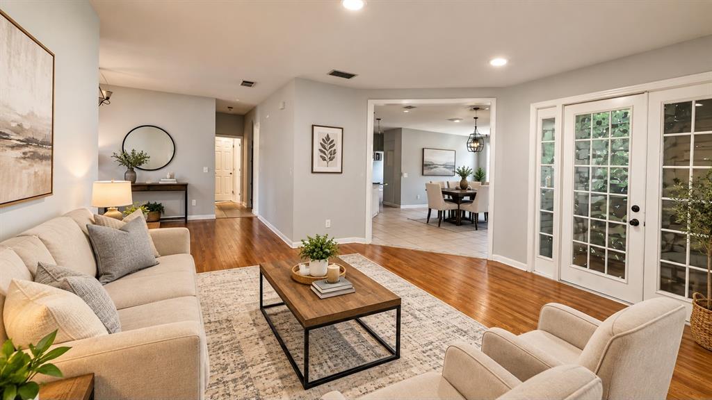 A living room features hardwood floors, a white front door, and two blue armchairs — 2601 GOLD DUST CIRCLE, KISSIMMEE, FL