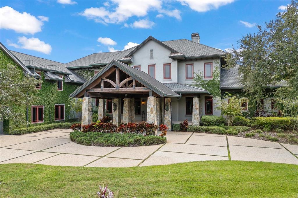 An aerial view shows a large house with a grey roof, swimming pool, and driveway — 586 WETHERSFIELD PLACE, MELBOURNE, FL
