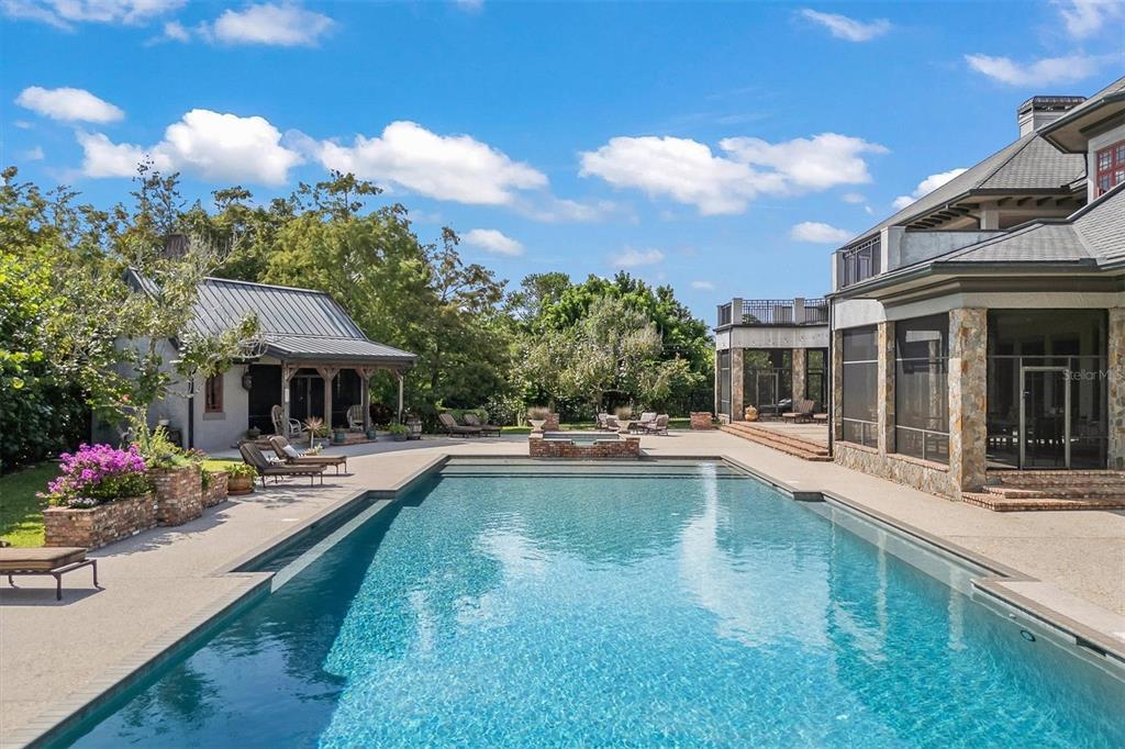 A large two-story house with a stone-pillared porte-cochère and ivy-covered walls — 586 WETHERSFIELD PLACE, MELBOURNE, FL