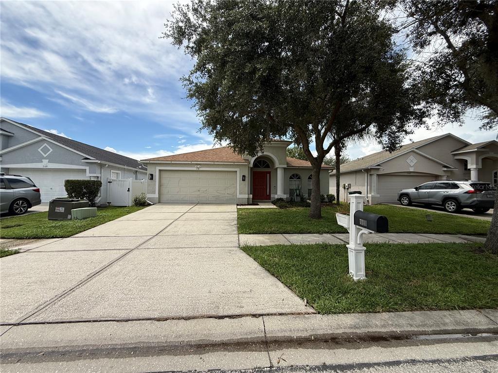 This collage displays various interior and exterior views of a residential property in Wesley Chapel — 7341 PULTENEY DRIVE, WESLEY CHAPEL, FL