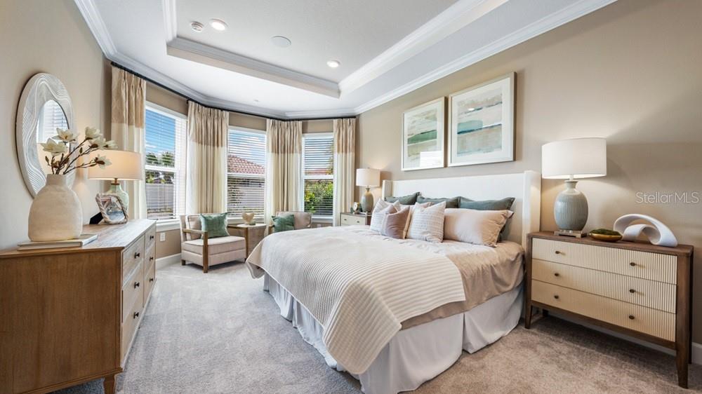 A bedroom features a king bed, two nightstands, a dresser, and a bay window area — 3931 IMMACOLATA WAY, WESLEY CHAPEL, FL