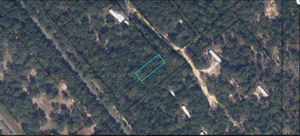 An aerial map view shows a rectangular plot of land outlined in blue amidst trees — 3RD STREET, KEYSTONE HEIGHTS, FL