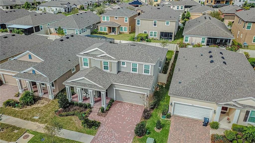 An aerial view shows several suburban houses with gray shingled roofs and paved driveways — 843 VISCOUNT STREET, BRANDON, FL