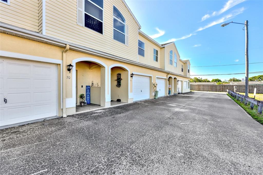 An aerial view shows the roof and front facade of a multi-unit townhouse complex — 6400 46TH AVENUE N UNIT 71, KENNETH CITY, FL