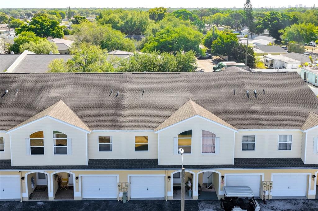 An entryway features a white door, a corner shelf, and white bi-fold closet doors — 6400 46TH AVENUE N UNIT 71, KENNETH CITY, FL