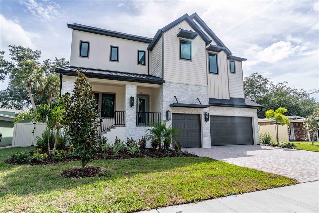 An aerial view shows a two-story house under construction with green sheathing and roofing — 4316 W CORONA STREET, TAMPA, FL