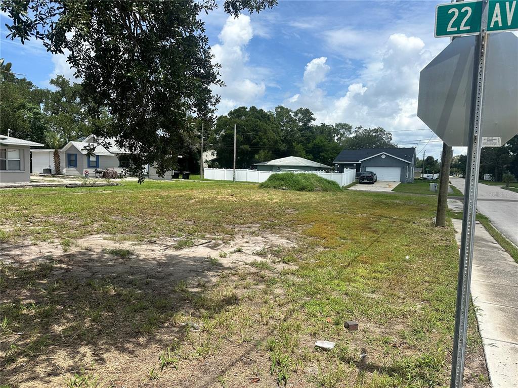 A vacant, grassy residential lot sits on a corner next to a street sign — 801 22ND AVENUE S, ST PETERSBURG, FL