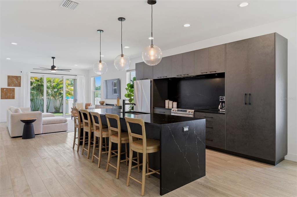 A modern, gray, single-story house with a flat roof and a concrete walkway — 5160 DARTMOUTH AVENUE N, ST PETERSBURG, FL