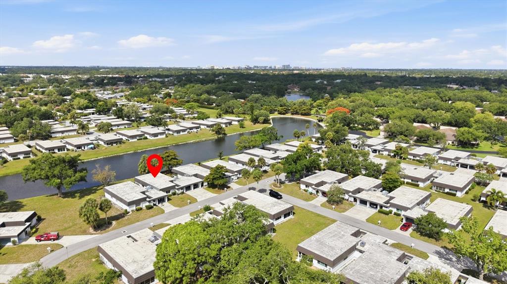 An aerial view shows a single-story residential building with a red pin near a lake — 3960 LAKESIDE ROAD UNIT 156, SARASOTA, FL