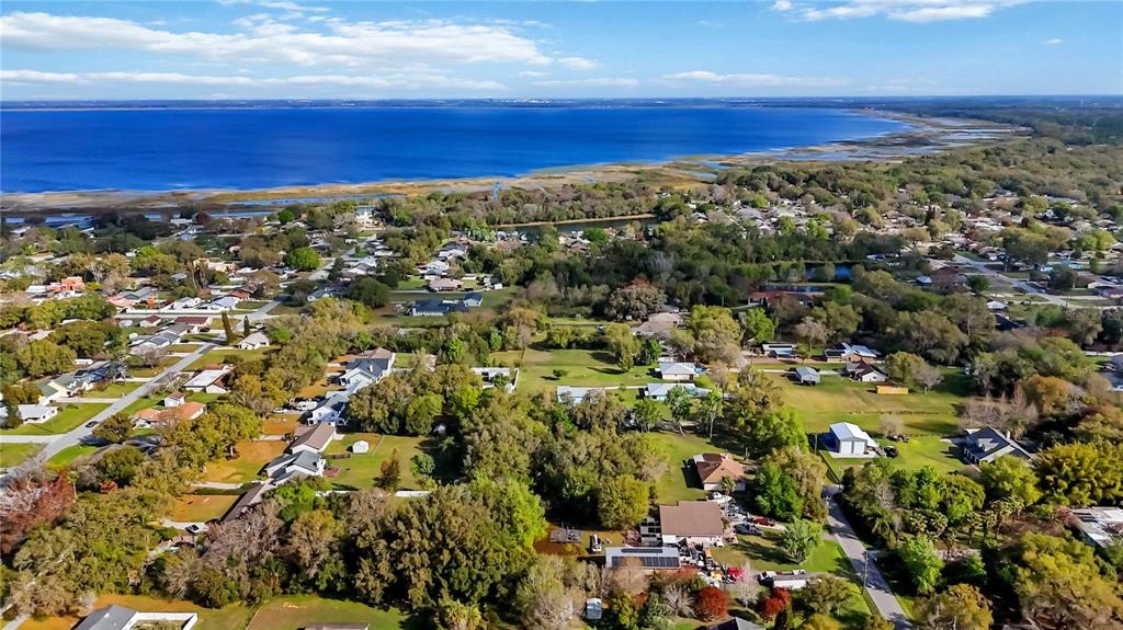 An aerial view shows a residential neighborhood situated along the shore of a large lake — 0 GRAPE AVENUE, ST CLOUD, FL