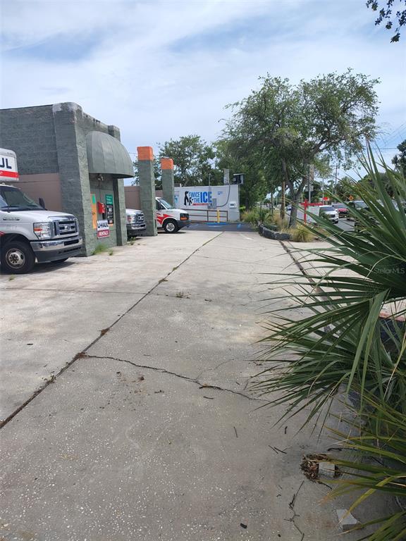 A paved parking lot features a U-Haul truck, a small ice vending station, and landscaping — 4902 S MANHATTAN AVENUE, TAMPA, FL