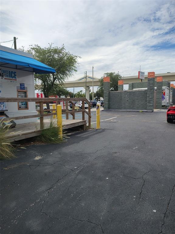 An outdoor view shows a Twice the Ice vending machine, a wooden deck, and a parking lot — 4902 S MANHATTAN AVENUE, TAMPA, FL