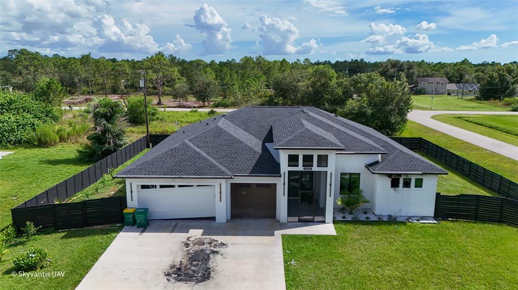 An aerial view of a modern single-story house with a dark roof and white exterior — 28005 PASADENA DRIVE, PUNTA GORDA, FL