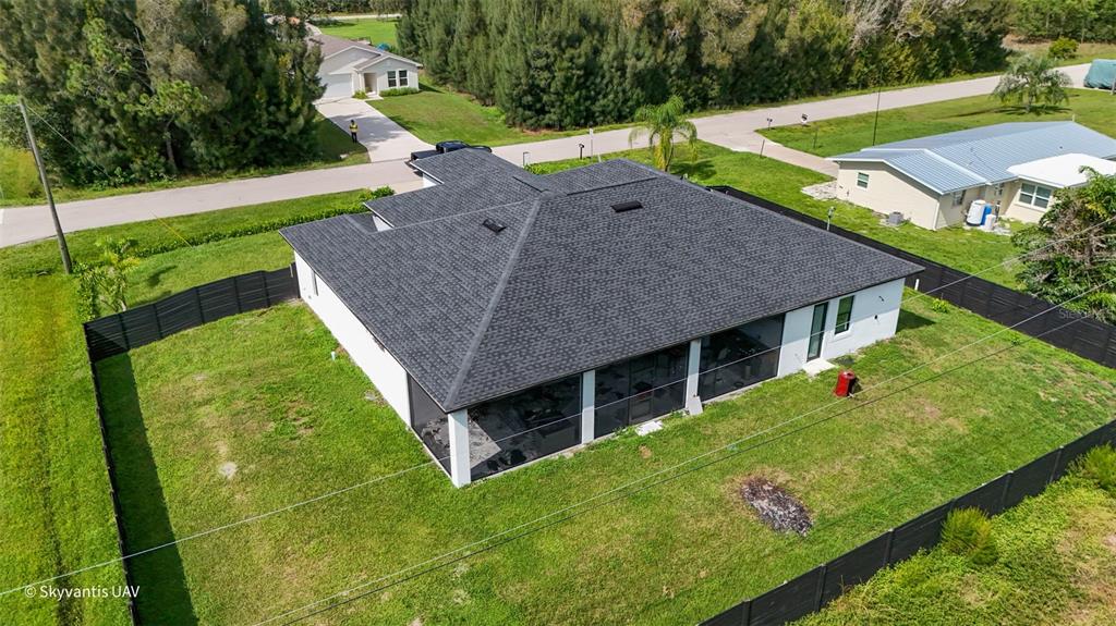 An aerial view of a white house with a dark shingled roof and screened lanai — 28005 PASADENA DRIVE, PUNTA GORDA, FL