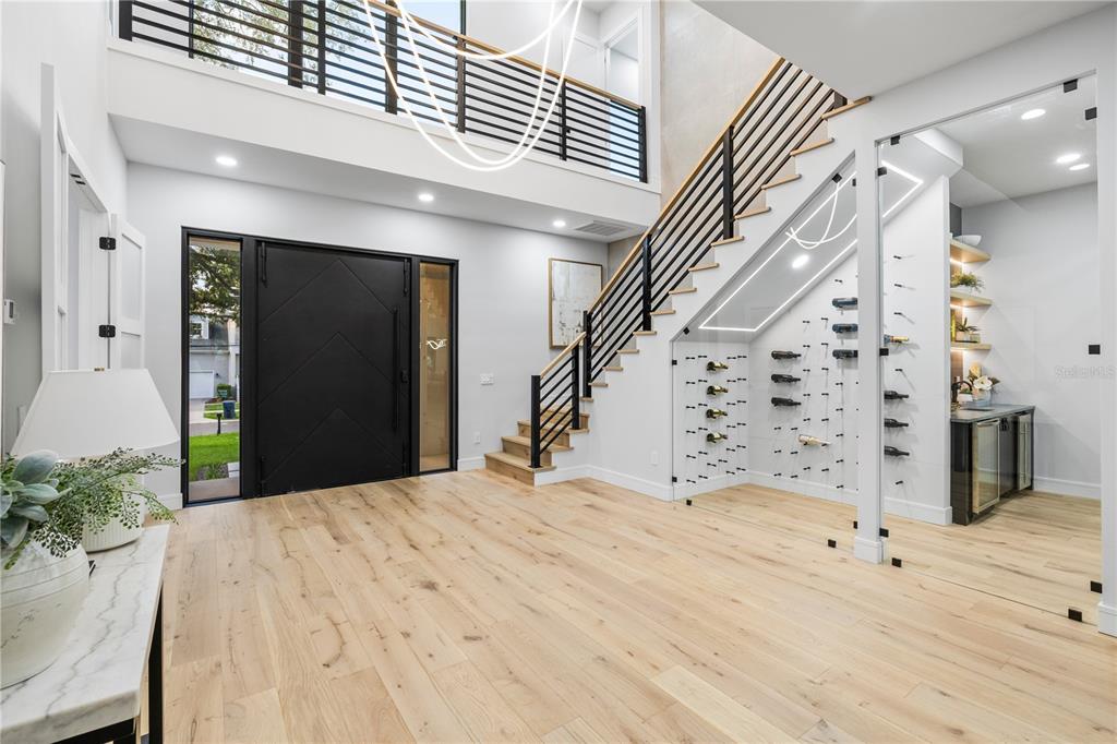 A modern black front door with geometric patterns is flanked by glass panels — 4709 W ESTRELLA STREET, TAMPA, FL