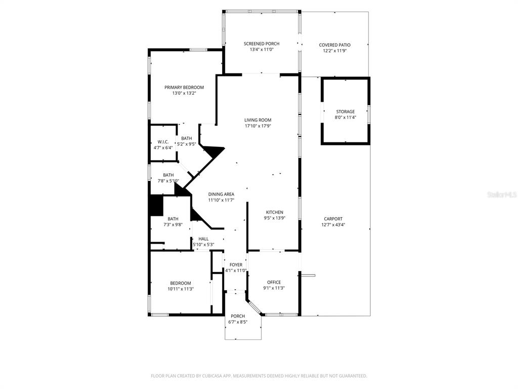 A kitchen with white cabinets and granite countertops overlooks a living area with a ceiling fan — 6114 GRAND OAKS DRIVE SE, WINTER HAVEN, FL