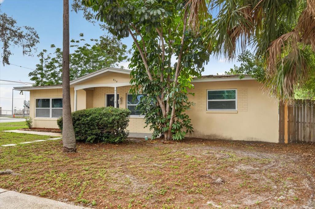 A single-story house with a yellow exterior, a front porch, and a large tree — 615 5TH AVENUE N, SAFETY HARBOR, FL