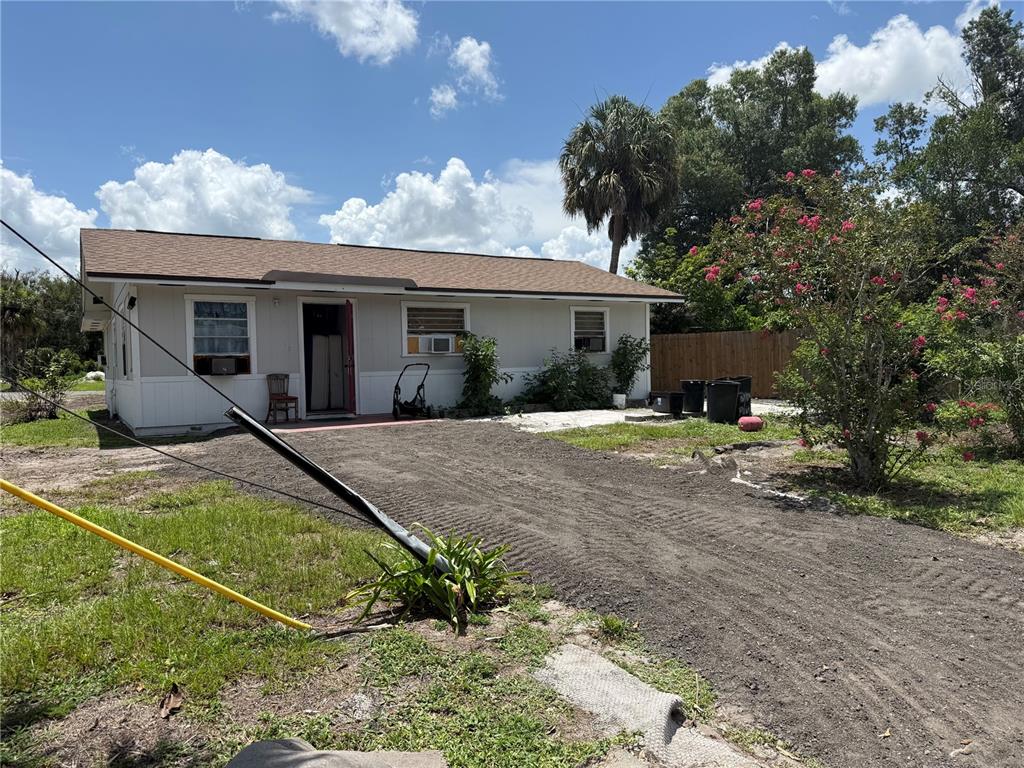 A single-story house with a light-colored exterior, a brown roof, and a dirt driveway — 326 E WHIDDEN STREET, ARCADIA, FL