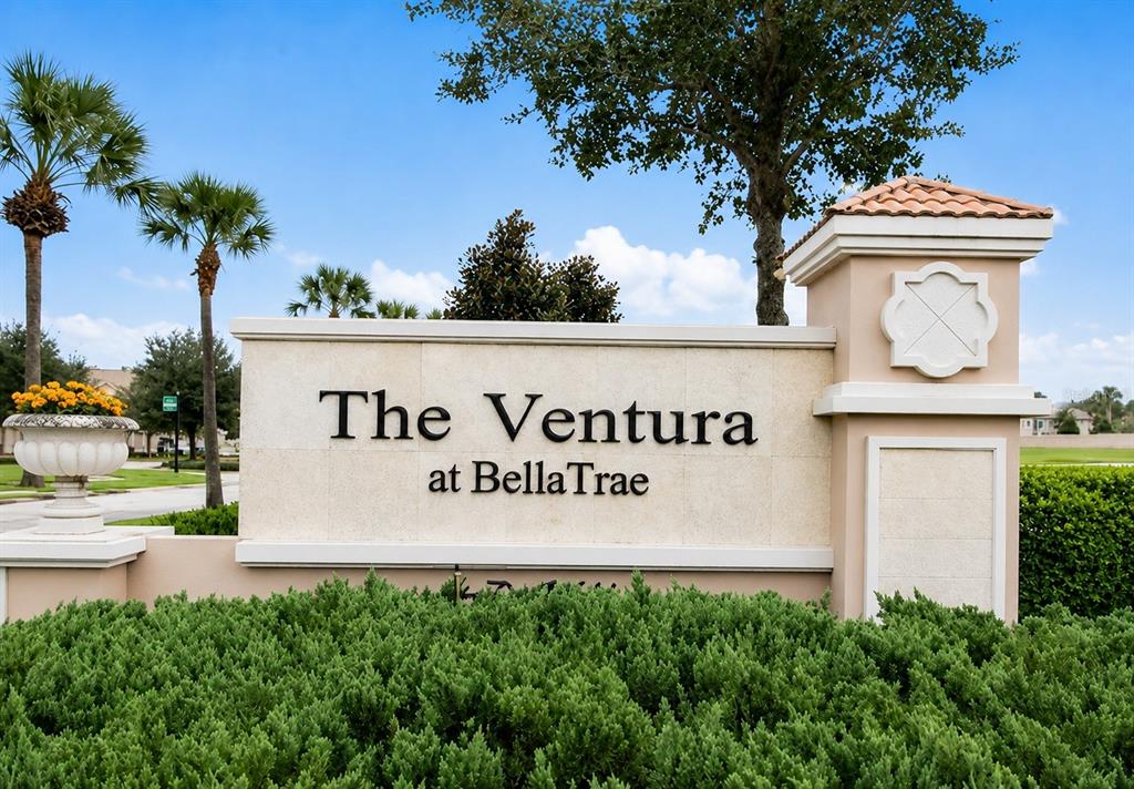 A stone monument sign for The Ventura at BellaTrae stands amidst landscaping and palm trees — 1357 VENEZIA COURT UNIT 303, DAVENPORT, FL