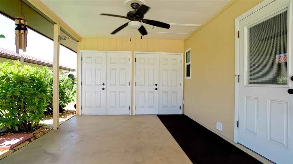 A covered patio features a ceiling fan, two sets of double doors, and a side door — 3305 NOTRE DAME PLACE, BRADENTON, FL