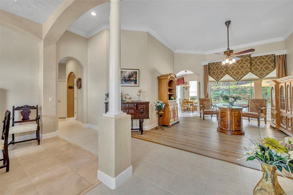 A living area with tile and wood flooring, a central pillar, and a dining nook — 2518 EMERALD TREE LANE, APOPKA, FL