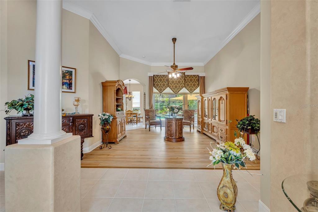 A living room features light wood flooring, a ceiling fan, and a large wooden cabinet — 2518 EMERALD TREE LANE, APOPKA, FL
