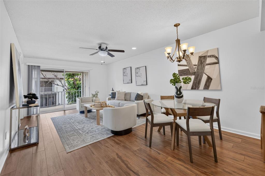 A kitchen with wood cabinets, a stainless steel dishwasher, and a view into the dining area — 3004 PLAZA TERRACE DRIVE UNIT 3004, ORLANDO, FL