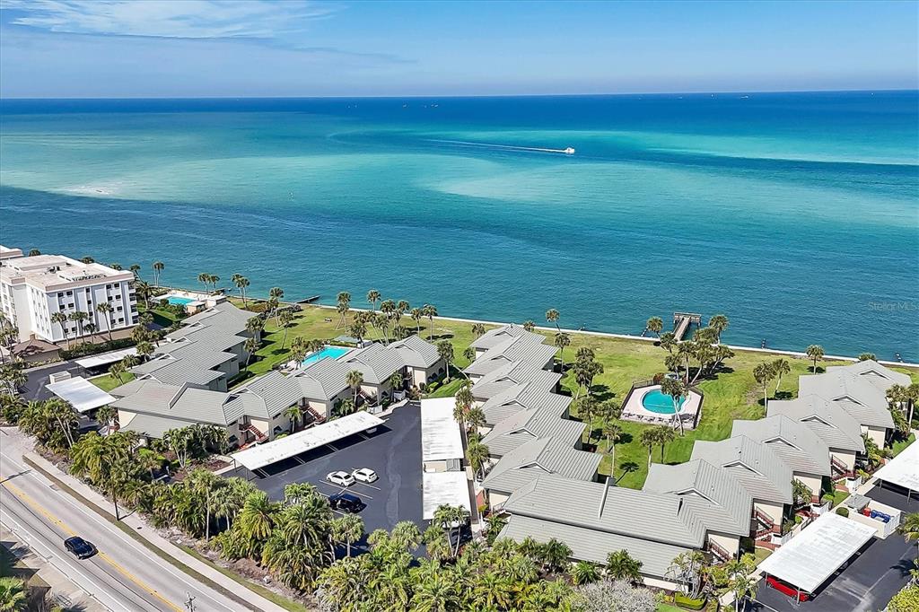 A two-story stucco building with exterior staircases and a private sign in the foreground — 4660 OCEAN BOULEVARD UNIT Q2, SARASOTA, FL