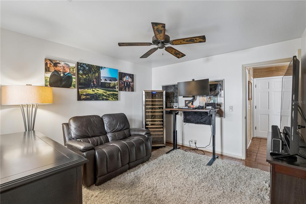 A blue front door with a glass panel sits beside a brick wall and window — 1256 MELISSA COURT, WINTER PARK, FL