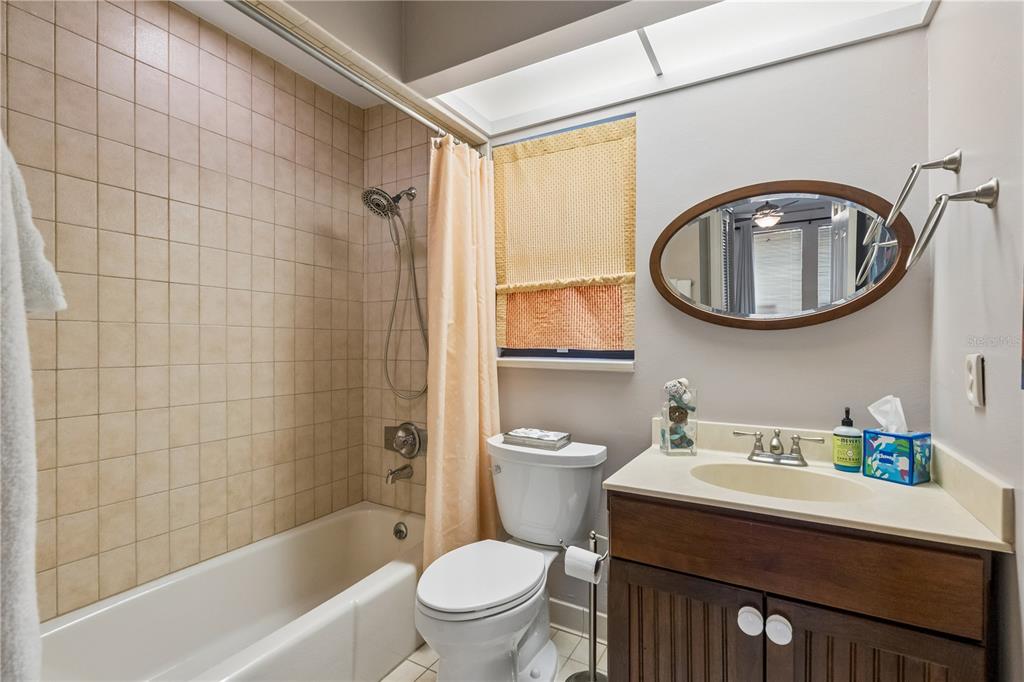 An interior view shows a carpeted staircase with wooden railings next to a tiled entryway — 1256 MELISSA COURT, WINTER PARK, FL
