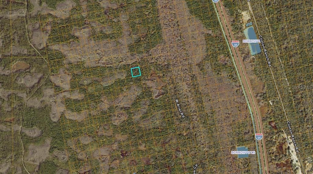 This aerial map shows a highlighted rectangular plot of land near a highway and road — NO STREET, OAK HILL, FL