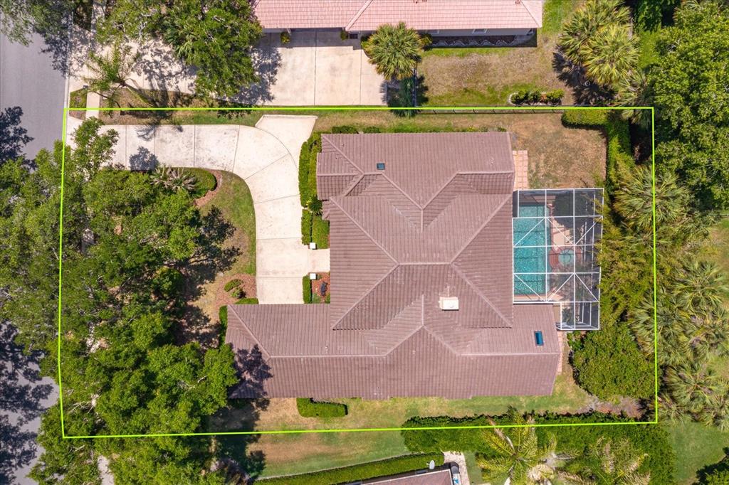 An aerial view shows a house with a tiled roof, a screened pool, and a driveway — 4965 SHORELINE CIRCLE, SANFORD, FL