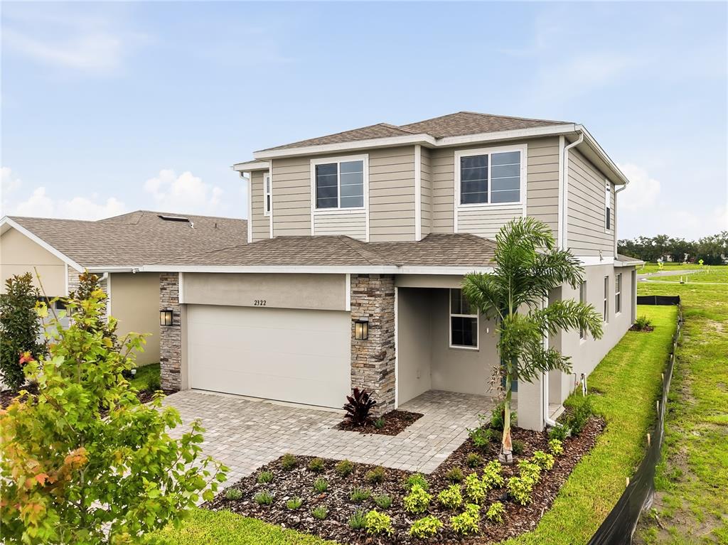 An aerial view shows a two-story house with a paved driveway in a new development — 2322 ANDERS DRIVE, PARRISH, FL