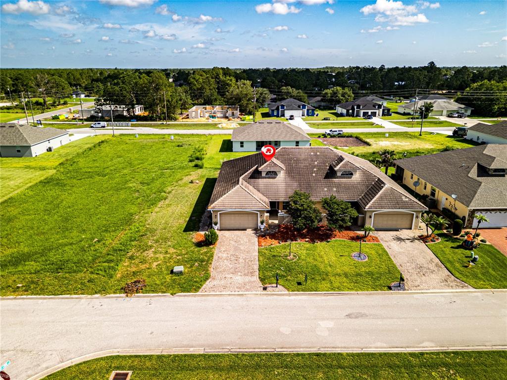 An aerial view shows a single-story house with a tiled roof and two attached garages — 6938 CECILIA AVENUE, SEBRING, FL